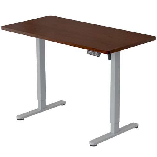 Image of fortia sit to stand up standing desk, 120x60cm, 72-118cm electric height adjustable, 40kg rated, walnut style/silver frame  suitable for aged care, corporate offices, and commercial settings