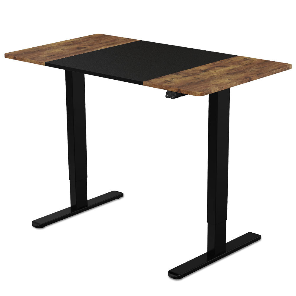 Image of fortia sit to stand up standing desk, 120x60cm, 72-118cm electric height adjustable, 70kg rated, walnut style/black frame suitable for aged care, corporate offices, and commercial settings