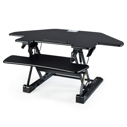 Image of fortia corner desk riser 110cm wide adjustable sit to stand for dual monitor, keyboard, laptop, black  suitable for aged care, corporate offices, and commercial settings