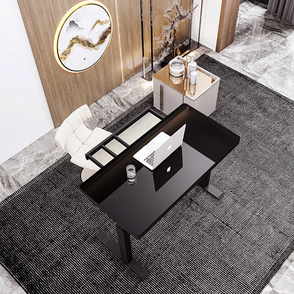 Image of black color electric standing desk electric height adjustable sit stand workstation toughened glass top single motor wireless charger suitable for aged care, corporate offices, and commercial settings
