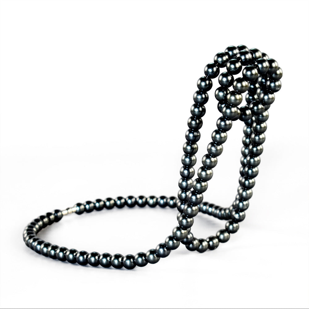 Image of black modern floating pearl wine bottle holder - elegant home decor, unique kitchen accessory for dining, bar, and living room ideal for luxury casual home interiors
