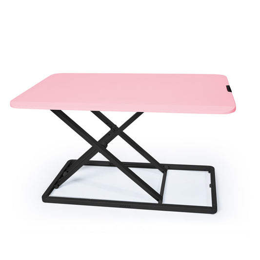 Image of fortia desk riser 74cm wide adjustable sit to stand for dual monitor, keyboard, laptop, pink  suitable for aged care, corporate offices, and commercial settings