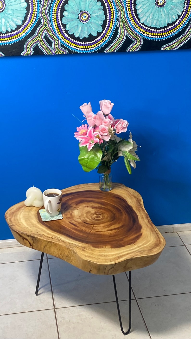 Image of round raintree wood live edge coffee table  ideal for luxury casual home interiors